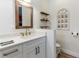 Bathroom features framed mirror, floating shelves, and modern fixtures at 3405 W Cherry St, Tampa, FL 33607
