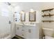 Bathroom with double sink vanity, stylish fixtures, and glass enclosed shower at 3405 W Cherry St, Tampa, FL 33607