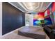 Bedroom features colorful mural, tray ceiling, neutral carpet, and natural light at 3405 W Cherry St, Tampa, FL 33607