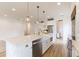 A spacious kitchen featuring stainless appliances, wood flooring, and a bright white island at 3405 W Cherry St, Tampa, FL 33607