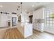 Bright kitchen with a large island, stainless steel appliances, wood floors, and ample cabinet space at 3405 W Cherry St, Tampa, FL 33607
