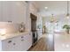 Well-lit kitchen featuring white cabinets, a large island, and wood flooring at 3405 W Cherry St, Tampa, FL 33607