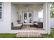 Cozy outdoor patio with comfortable seating, ceiling fan, and access to the backyard, ideal for relaxation at 3405 W Cherry St, Tampa, FL 33607