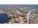 Aerial view of a home and its community, near a golf course and lake at 3810 Chaucer Way, Land O Lakes, FL 34639