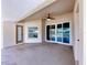 The covered patio includes a ceiling fan and sliding glass doors to the interior at 3810 Chaucer Way, Land O Lakes, FL 34639