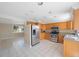 Bright kitchen with stainless appliances and tile flooring adjacent to dining area at 4226 Woodfield Ave, Holiday, FL 34691