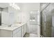 Bathroom with a double sink vanity, quartz countertop, and a tiled walk-in shower at 4275 Big Sky Dr, Spring Hill, FL 34604
