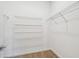 Walk-in closet equipped with built-in shelving for optimal storage and organization at 4275 Big Sky Dr, Spring Hill, FL 34604