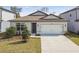 Charming single-story home featuring a two-car garage and well-maintained front yard with manicured landscaping at 4275 Big Sky Dr, Spring Hill, FL 34604