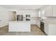 Bright kitchen featuring stainless steel appliances, white cabinets, tile flooring, and a quartz island at 4275 Big Sky Dr, Spring Hill, FL 34604