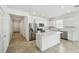 Bright kitchen featuring stainless steel appliances, white cabinets, tile flooring, and a quartz island at 4275 Big Sky Dr, Spring Hill, FL 34604