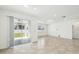 Bright, open-concept living room featuring tile flooring, recessed lighting, and sliding doors to the backyard at 4275 Big Sky Dr, Spring Hill, FL 34604