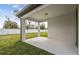Covered outdoor patio area perfect for relaxing and entertaining with views of the landscaped backyard at 4275 Big Sky Dr, Spring Hill, FL 34604