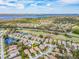 Breathtaking aerial view of Oakmont community with serene water views, lush landscaping, and luxurious homes at 4372 Water Oak Way, Palm Harbor, FL 34685