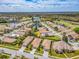 Aerial view of a neighborhood with manicured lawns and mature trees at 4372 Water Oak Way, Palm Harbor, FL 34685