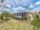 Well-maintained backyard featuring a screened lanai and manicured hedges at 4372 Water Oak Way, Palm Harbor, FL 34685