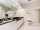 Bathroom with double sinks, granite countertops, and ample storage at 4372 Water Oak Way, Palm Harbor, FL 34685