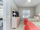 Well lit bedroom with two twin beds, dresser, and view of the neighborhood at 4372 Water Oak Way, Palm Harbor, FL 34685