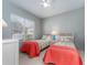 Bright bedroom featuring two twin beds, soft lighting, and a ceiling fan at 4372 Water Oak Way, Palm Harbor, FL 34685