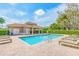 Community pool area with lounge chairs and a covered building at 4372 Water Oak Way, Palm Harbor, FL 34685