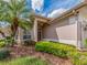 Inviting home facade with a palm tree, a tiled roof, and neat landscaping around the front entrance at 4372 Water Oak Way, Palm Harbor, FL 34685