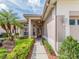 Welcoming front entrance, framed by lush landscaping, a well-kept walkway, and a tiled roof at 4372 Water Oak Way, Palm Harbor, FL 34685