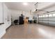 Spacious garage with epoxy flooring, storage cabinets, and overhead door at 4372 Water Oak Way, Palm Harbor, FL 34685