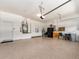 Spacious garage with epoxy flooring, storage cabinets, and access door at 4372 Water Oak Way, Palm Harbor, FL 34685