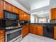 Features stainless steel appliances, wood cabinets, and granite countertops at 4372 Water Oak Way, Palm Harbor, FL 34685