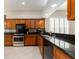 Features stainless steel appliances, wood cabinets, and granite countertops at 4372 Water Oak Way, Palm Harbor, FL 34685