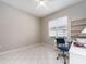 Sunlit home office with tile flooring and built-in shelves at 4372 Water Oak Way, Palm Harbor, FL 34685
