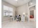 Bright office with desk, tiled floors, a ceiling fan, and a view of the outside at 4372 Water Oak Way, Palm Harbor, FL 34685