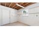 Unfinished basement featuring an exposed ceiling, natural light, and shelving on the cinder block walls at 4517 S Renellie Dr, Tampa, FL 33611