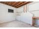 Unfinished basement with exposed wooden beams, concrete floors, and shelving at 4517 S Renellie Dr, Tampa, FL 33611