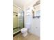 Bathroom featuring a shower with green tile, a toilet, and an ornate decorative mirror at 4517 S Renellie Dr, Tampa, FL 33611