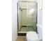 Bathroom featuring a shower with green tile and black trim, and a toilet at 4517 S Renellie Dr, Tampa, FL 33611