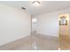 Bright bedroom featuring terrazzo floors, neutral walls, and a spacious closet with an ensuite bathroom at 4517 S Renellie Dr, Tampa, FL 33611