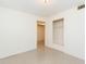 Cozy bedroom featuring neutral walls and tiled floor, with closet and hallway access at 4517 S Renellie Dr, Tampa, FL 33611