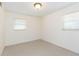 Neutral bedroom with two windows and carpeted floors at 4517 S Renellie Dr, Tampa, FL 33611