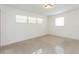 Bright bedroom featuring natural light from large windows, and terrazzo flooring throughout at 4517 S Renellie Dr, Tampa, FL 33611