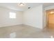 Cozy bedroom featuring natural light from a window and tiled floors throughout at 4517 S Renellie Dr, Tampa, FL 33611