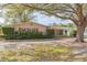 Charming single-story home featuring a well-manicured lawn and mature trees providing ample shade at 4517 S Renellie Dr, Tampa, FL 33611