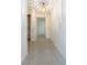 Bright hallway with light fixture and durable terrazzo flooring, offers a clean and spacious feel at 4517 S Renellie Dr, Tampa, FL 33611