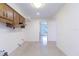 Kitchen area with wooden cabinets and access to other rooms, offering modernization potential at 4517 S Renellie Dr, Tampa, FL 33611