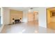 Open living room featuring a decorative fireplace, terrazzo floors, and natural light at 4517 S Renellie Dr, Tampa, FL 33611