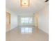 Bright living room featuring large windows, unique light fixture, and a smooth terrazzo floor at 4517 S Renellie Dr, Tampa, FL 33611