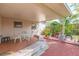 Covered back patio with outdoor furniture, brick floor, well-maintained plants, and relaxing ambiance at 4517 S Renellie Dr, Tampa, FL 33611