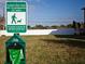 Pet-friendly community area with dog waste station and signage, surrounded by green lawn at 505 51St N Ave, St Petersburg, FL 33703