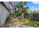 Private backyard featuring a built-in brick grill and lush tropical landscaping at 511 27Th N Ave, St Petersburg, FL 33704