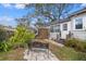 Secluded backyard featuring a bench, mature trees, a shed, and a well-maintained lawn at 511 27Th N Ave, St Petersburg, FL 33704